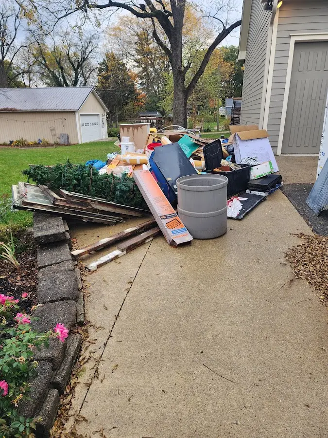 Dumpster being loaded with debris for 10 Yard Dumpster Rental in Bixby